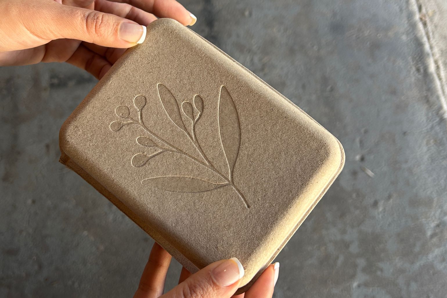 Molded pulp packaging with wrap around branded sleeves